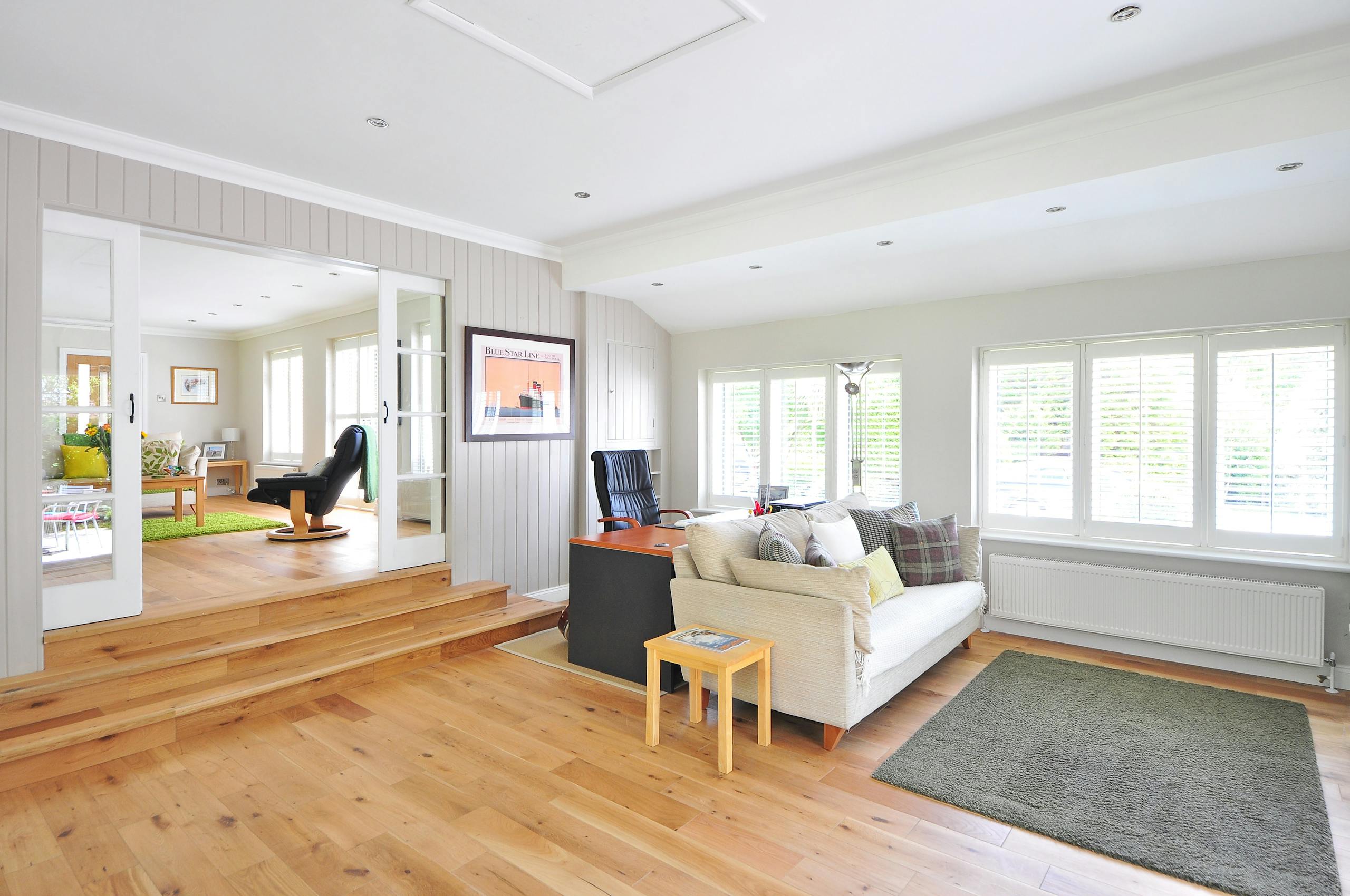 spacious and bright modern living room with wooden floors and stylish furniture. 259962 scaled